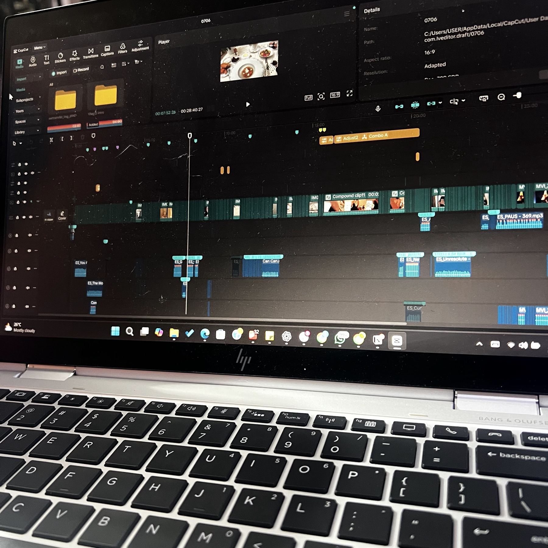 A detailed CapCut video-editing timeline open on a laptop.
